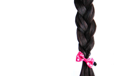 Black braided hair isolated on white background. Brunette natural braided hair extension on white backgroundの写真素材