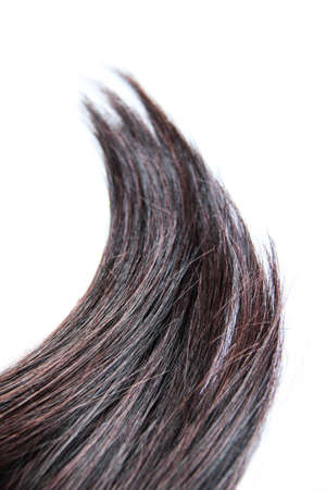 Black hair isolated on white background. Brunette natural hair extension on white backgroundの写真素材