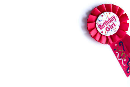 Happy birthday wishes for a girl on a pink badge on white backgroundの写真素材