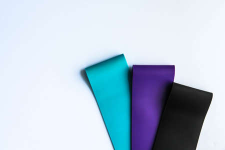 Fitness elastic band, elastic extenders of different colors for sports, isolated on a white background.の写真素材
