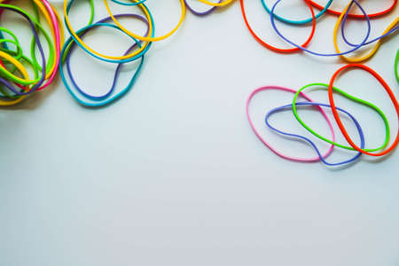 Top view of colorful rubber bands isolated on white. Rainbow elastic rubber bands on white. Space for textの写真素材