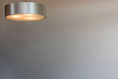 Glowing modern aluminum led lamp with white wall. Free space for text or design. Space for textの写真素材