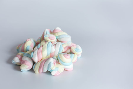 Colored twisted marshmallow on whiteの写真素材