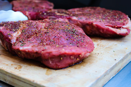 Marinated with spices raw bbq meat on a wood. Summer conceptの写真素材