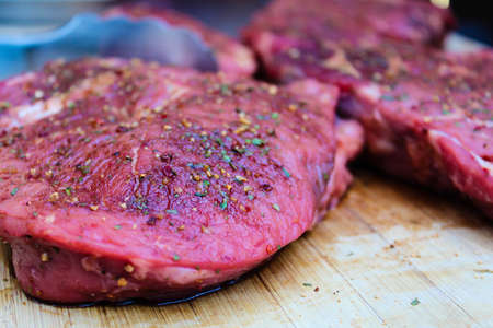 Marinated with spices raw bbq meat on a wood. Summer conceptの写真素材