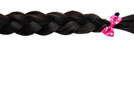 Black braided hair isolated on white background. Brunette natural braided hair extension on white backgroundの写真素材