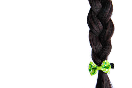 Black braided hair isolated on white background. Brunette natural braided hair extension on white backgroundの写真素材