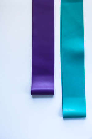 Fitness elastic band, elastic extenders of different colors for sports, isolated on a white background.の写真素材