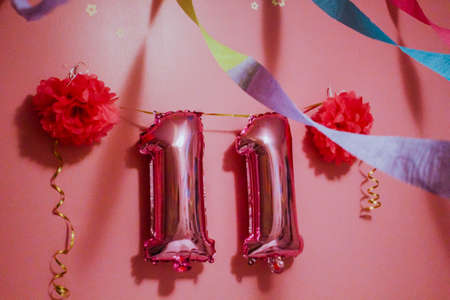 Birthday balloons wall. 11 years birthday. Pink wall with balloons and ribbons.の写真素材