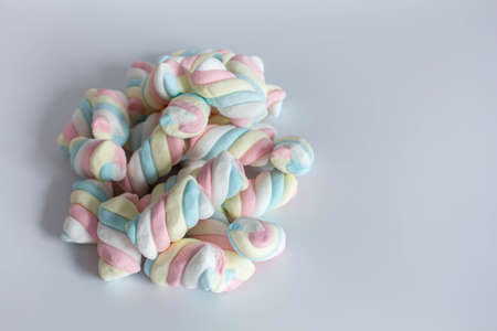 Colored twisted marshmallow on whiteの写真素材