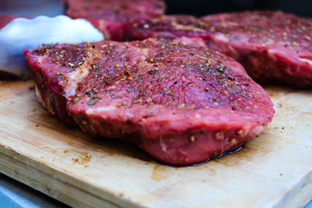 Marinated with spices raw bbq meat on a wood. Summer conceptの写真素材