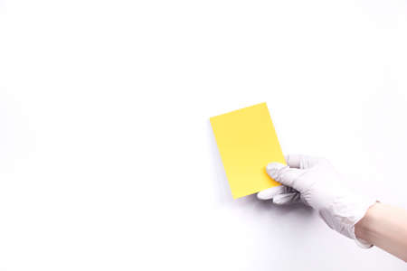 Women's hands hold swatches of the trendy color - illuminating yellow. Selection of year 2021 colors for design of clothes, interiors, websites and publications. Flat lay.の写真素材
