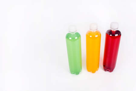 Energy drinks bottles with different flavors on a white background. Juice bottlesの写真素材