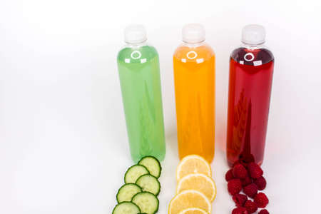 Various smoothies or juices in bottles and ingredients on white, healthy diet raw detox vegan clean food conceptの写真素材