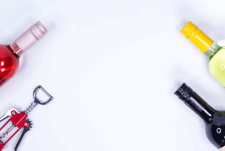 Red, rose and white wine bottles on white table. Top view with copy spaceの写真素材