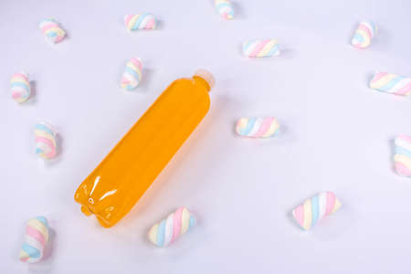 Bottle of orange smoothie on white background. Top view. Detox summer drink. Healthy fresh juice bottle. Vegan and vegetarian concept.の写真素材