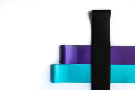 Fitness elastic band, elastic extenders of different colors for sports, isolated on a white background.の写真素材