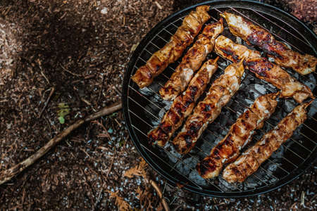 Barbeque meat on charcoal grill top viewの写真素材