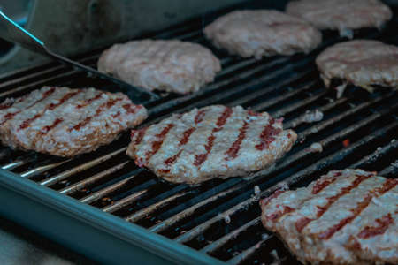 Smoky hamburger meat grilling for burgers. BBQ Grilled Burgers Patties.の写真素材
