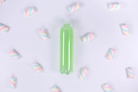 Bottle of green smoothie on white background. Top view. Detox summer drink. Healthy fresh juice bottle. Vegan and vegetarian concept.の写真素材