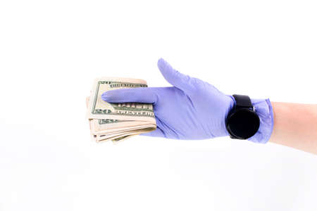 World money concept, hand with gloves receiving, giving or holding 20 USD banknote, isolated on blurred background.     Concept of prevention virus spreadの写真素材