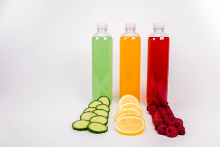 Various smoothies or juices in bottles and ingredients on white, healthy diet raw detox vegan clean food conceptの写真素材