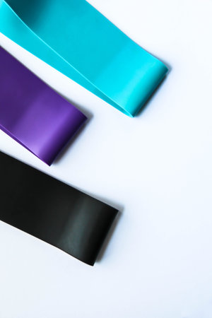 Fitness elastic band, elastic extenders of different colors for sports, isolated on a white...