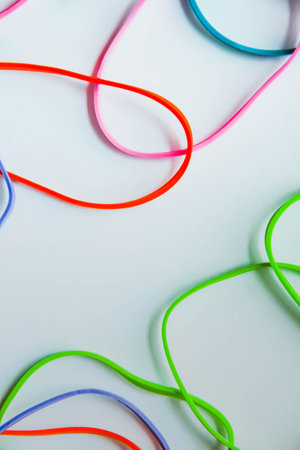 Top view of colorful rubber bands isolated on white. Rainbow elastic rubber bands on white. Space for textの写真素材