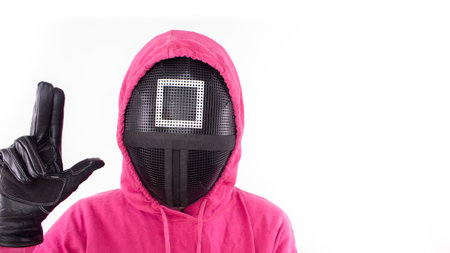 Pink Guard from Squid Game of new Netflix show. Squid Game red guard on white background. Space for text. South Korean survival drama television series.のeditorial素材