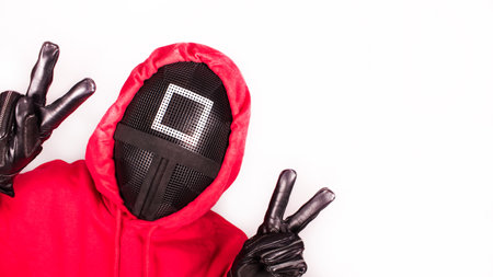 Squid Game red guard with piece sign hands on white background. Space for text. Pink Guard from Squid Game of new Netflix show. South Korean tv series. Gatineau, Quebec Canada - November 2, 2021のeditorial素材