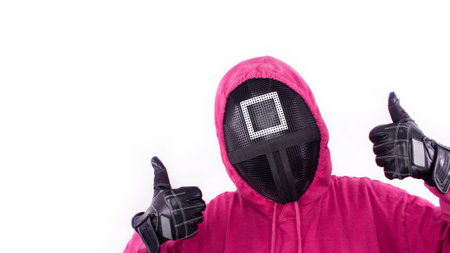Squid Game red guard with thumbs up sign on white background. Space for text. Pink Guard from Squid Game of new Netflix show. South Korean tv series. Gatineau, Quebec Canada - November 2, 2021のeditorial素材