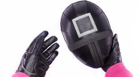 POV view of hands of Squid Game pink guard holding a mask on white background. Space for text. Red Guard from Squid Game of new Netflix show. Gatineau, Quebec Canada - November 2, 2021のeditorial素材