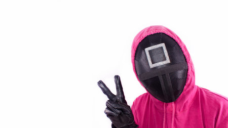 Squid Game red guard with piece sign hand on white background. Space for text. Pink Guard from Squid Game of new Netflix show. South Korean tv series. Gatineau, Quebec Canada - November 2, 2021のeditorial素材