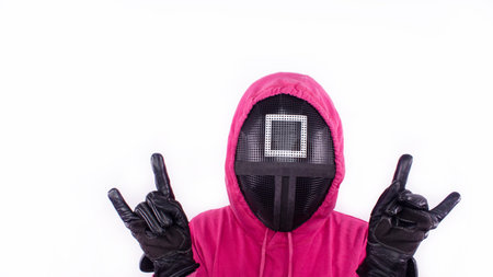 Squid Game red guard with rock horns sign hands on white background. Space for text. Pink Guard from Squid Game of new Netflix show. South Korean tv series. Gatineau, Quebec Canada - November 2, 2021のeditorial素材
