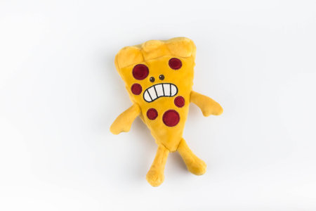 Colorful plush pizza piece on isolated white background.の写真素材