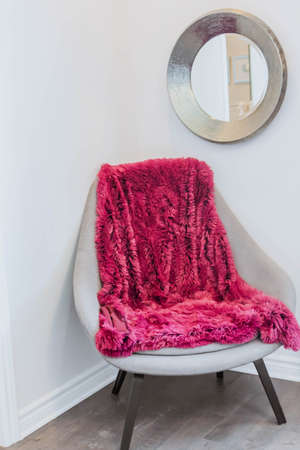 Giant Pink Plaid Blanket Woolen Knitted on White Stool Chair Home Scandinavian Style mirrorの写真素材