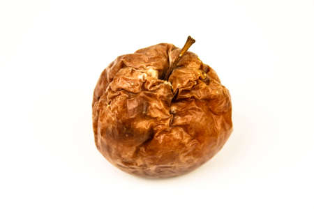 Old rotten apple with large DOF on white background.の写真素材