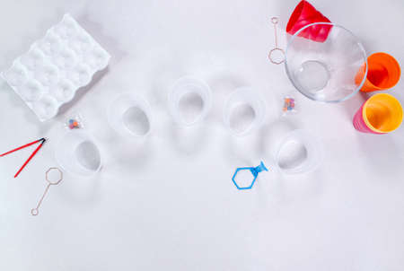 Tools for painting eggs for easter, eggs box, easter eggs, plate, brushes and paints on the table side view.の写真素材