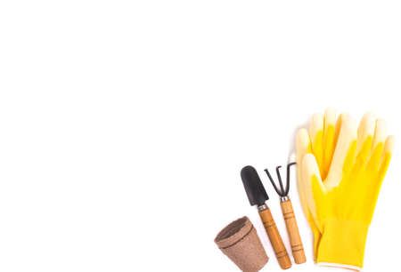 Garden shovels, gloves, recyclable plant pots on a white background . Gardening layout. Spring planting season. Work in the ground. Copy space.の写真素材