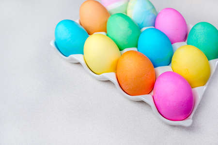 Pastel Easter eggs lying on white table. Traditional decorationの写真素材