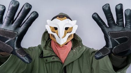 Ekko Firelight masked man from Arcane Netflix TV series. Masked man is holding hands close to camera. League of Legends. Popular tv show. Ekko's owl mask boy. June 18, 2022 - Gatineau, QC Canadaのeditorial素材