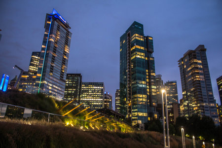 Cityscape at Night. Skyscrapers illuminated at night. Evening illumination in downtown in Vancouver,...