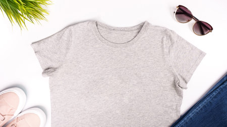 Light grey unisex t shirt mock up flat lay on white background. Top front view t-shirt, snikers, jeans, sunglasses and copy space. Mockup t-shirt and summertime. Template blank shirtの写真素材