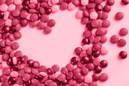 Color of year 2023 Viva Magenta. Image with heart made of candy is toned in color of viva magenta....