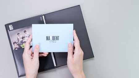 Hands holding Stray Kids MAXIDENT mini Album Box set on grey. Pink music CD. South Korean boy band StrayKids. Space for text. Gatineau, QC Canada - December 07 2022.のeditorial素材