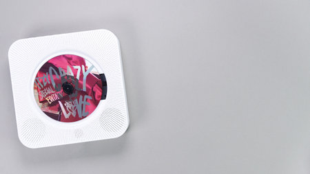 1st music album of k-pop group Itzy CRAZY IN LOVE is playing music in white music retro player on grey background. South Korean girl group Itzy. Gatineau, QC Canada - November 10 2022.のeditorial素材