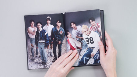 Fan holding Stray Kids MAXIDENT mini Album photobook on grey. Music CD. South Korean boy band StrayKids. Space for text. Gatineau, QC Canada - December 07 2022.のeditorial素材