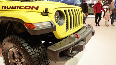 Close up view of yellow Rubicon Jeep car on display. Crowds looking at new car models at Auto show. National Canadian Auto Show with many car brands. Toronto ON Canada Feb 19, 2023のeditorial素材