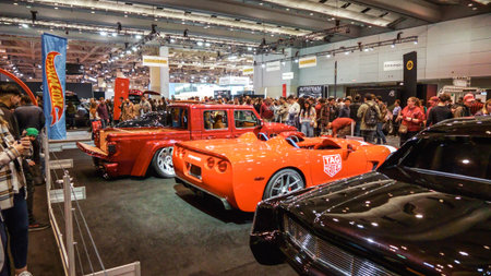 Crowds looking at new car models at Auto show. Vintage custome cars on display. National Canadian...