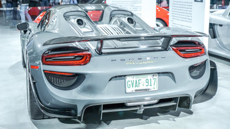 Crowds looking at new car models at Auto show. Porsche Spyder car on display. National Canadian Auto Show with many car brands. Toronto ON Canada Feb 19, 2023のeditorial素材